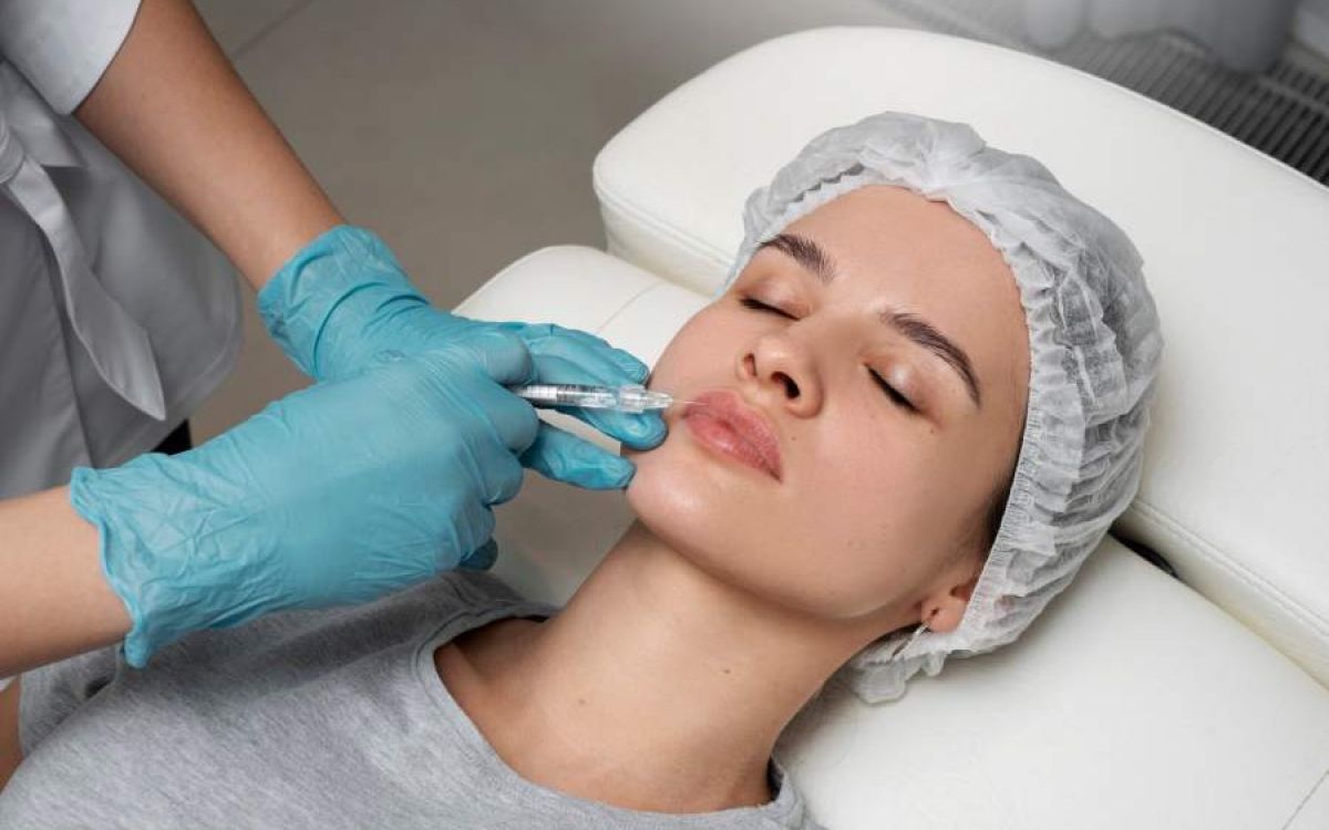 Nurse injector holding a syringe of hyaluronic acid dermal filler at Savage Serenity MedSpa in Fresno